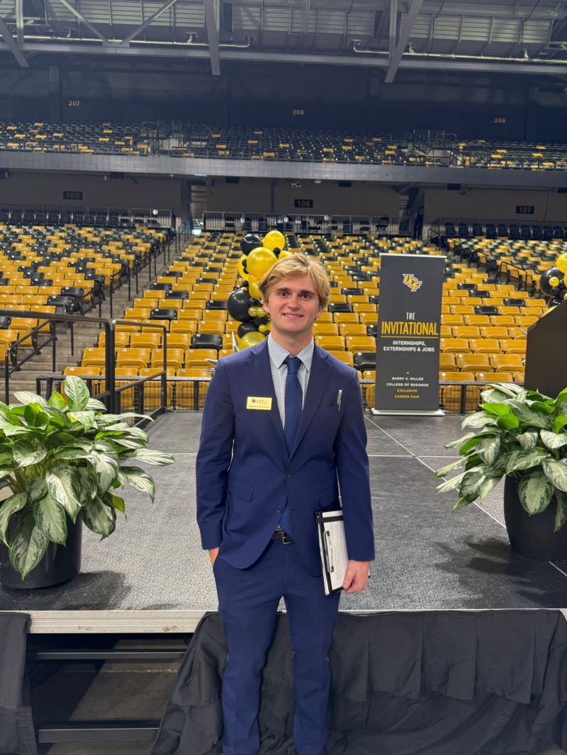 Christian in a navy suit at UCF's Invitational career fair