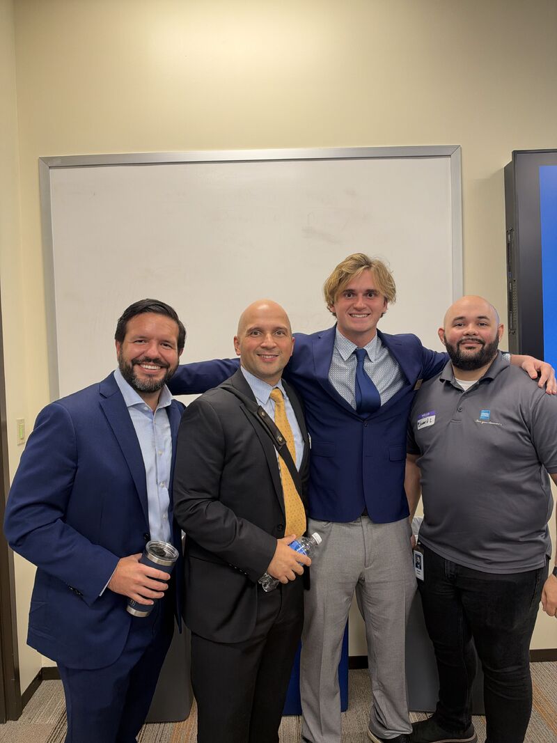 Christian with professionals at a Charles Schwab event